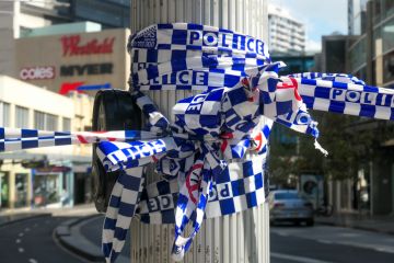 NSW Police cordon tape wrapped around a light pole. This image was taken at the corner of Oxford Street and Hollywood Avenue, Bondi Junction NSW Police cordon tape wrapped around a light pole. This image was taken at the corner of Oxford Street and Hollywood Avenue, Bondi Junction