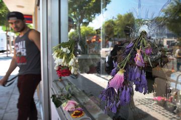 Flowers fill bullet holes in the windows of the IV Deli on May 25, 2014 in Isla Vista, California, after Elliot Rodger’s murderous rampage Flowers fill bullet holes in the windows of the IV Deli on May 25, 2014 in Isla Vista, California, after Elliot Rodger’s murderous rampage