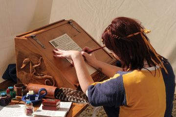 Woman writing dressed in medieval clothes Woman writing dressed in medieval clothes