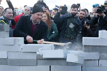 Protesters smash through mock wall Protesters smash through mock wall