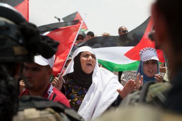 Palestinian women confront Israeli soldiers in a demonstration near Susya in the South Hebron Hills