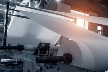 Paper being processed in paper mill Paper being processed in paper mill
