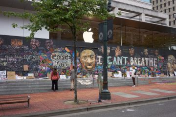 wntown Portland's Pioneer Place, which has become unofficial canvases for peaceful protest. Passers-by stop and take a look at the boarded-up Apple Store in downtown Portland's Pioneer Place, which has become unofficial canvases for peaceful protest.