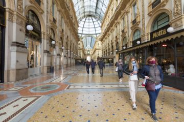 Pedestrians wearing protective face masks in Galleria Vittorio Emanuele II in Milan