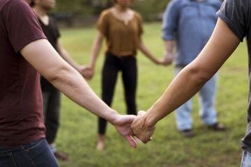 People hold hands in a circle