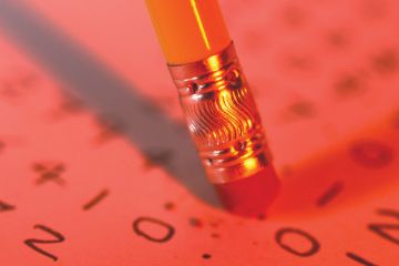 Pencil eraser erasing text from paper