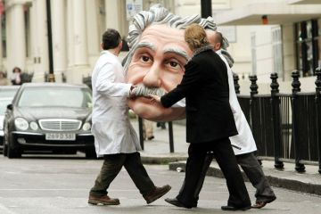 People carrying model of Albert Einstein's head, Science Museum, London, England People carrying model of Albert Einstein's head, Science Museum, London, England