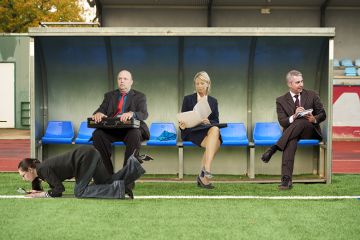 People in suits sitting on a soccer substitute bench. To illustrate that Skills England has no clear role in forming or implementing policy. People in suits sitting on a soccer substitute bench. To illustrate that Skills England has no clear role in forming or implementing policy.