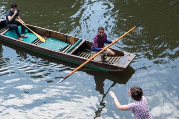 People on boats punting on River Cam, Cambridge People on boats punting on River Cam, Cambridge