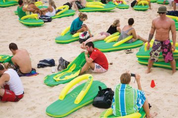 People sitting on the beach on giant lilos People sitting on the beach on giant lilos