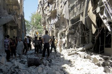People standing among rubble of destroyed buildings, Aleppo, Syria People standing among rubble of destroyed buildings, Aleppo, Syria