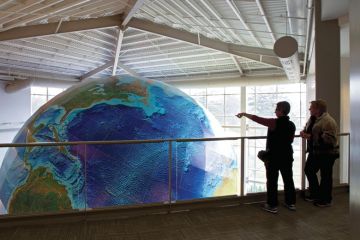 People viewing rotating globe, DeLorme Map Store, Yarmouth, Maine People viewing rotating globe, DeLorme Map Store, Yarmouth, Maine