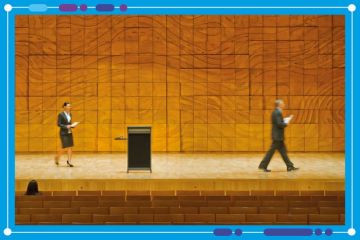 Man leaving stage whilst a woman walks towards lecturn. To illustrate leadership churn in higher education Man leaving stage whilst a woman walks towards lecturn. To illustrate leadership churn in higher education
