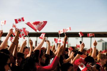 People waving Canadian flags