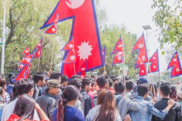 People at rally with Nepalese flags in Kathmandu