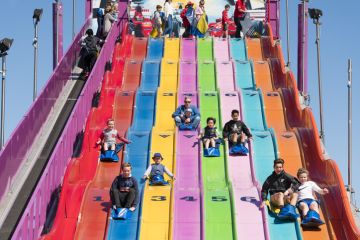 People enjoying a giant slide at the 2015 Royal Melbourne Show