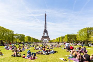 People on Champ de Mars with Eiffel Tower in background People on Champ de Mars with Eiffel Tower in background