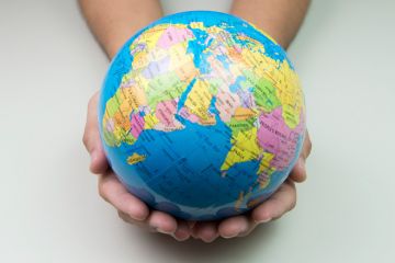 Person holding world in hands (university rankings)