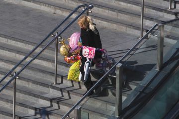 Person laden with children's presents, Westfield shopping centre Person laden with children's presents, Westfield shopping centre