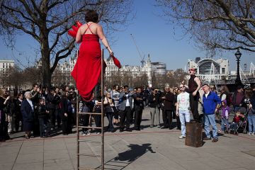 A busker performs balancing on a ladder for a crowd along the Southbank. London. To illustrate that pay awards offered to staff at universities that do not participate in collective bargaining have risen above the national offer. A busker performs balancing on a ladder for a crowd along the Southbank. London. To illustrate that pay awards offered to staff at universities that do not participate in collective bargaining have risen above the national offer.