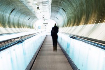 Person standing on moving walkway Person standing on moving walkway