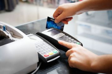 Person swiping credit card instore Person swiping credit card instore