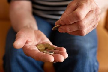 Person counting money in hand