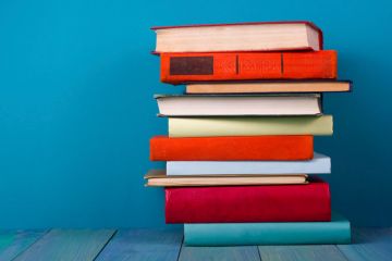 Pile of books against blue background