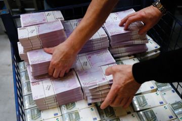 Piles of euro banknotes being counted and stacked Piles of euro banknotes being counted and stacked