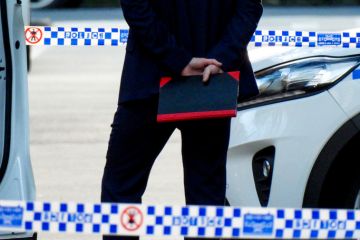 plain clothes detective holding a notebook