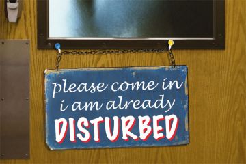 'Please come in, I am already disturbed' sign on door