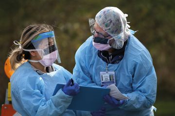 two healthcare workers in PPE