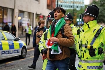 Police detain a man with a Palestine flag at a vigil for Israel held by Manchester Jewish Community in Manchester Police detain a man with a Palestine flag at a vigil for Israel held by Manchester Jewish Community in Manchester