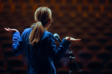A public speaker shrugs