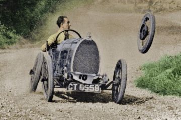 Racecar losing wheel as it turns corner Racecar losing wheel as it turns corner