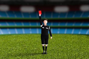 A football referee issues a red card A football referee issues a red card