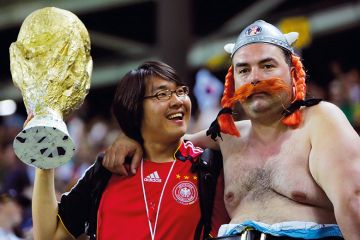 A South Korean supporter (L) holds a miniature replica of the World Cup trophy A South Korean supporter (L) holds a miniature replica of the World Cup trophy to illustrate Overseas drive ‘puts HE quality at risk’