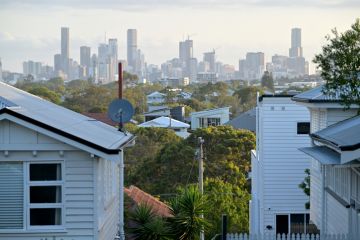 Residential houses against Brisbane City skyline in Queensland Australia Residential houses against Brisbane City skyline in Queensland Australia