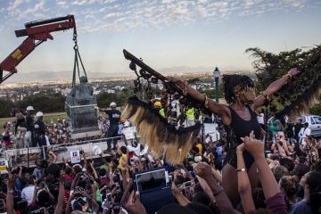 Students cheer as the Cecil Rhodes statue is being removed from the University of Cape Town on April 9, 2015