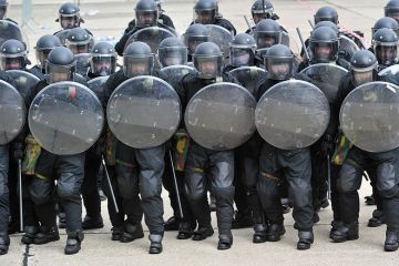 Riot police with shields Riot police with shields