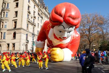 Ronald McDonald balloon hits the ground as it is pulled along Central Park West during the annual Macy's Thanksgiving Day Parade in New York City, Ronald McDonald balloon hits the ground as it is pulled along Central Park West during the annual Macy's Thanksgiving Day Parade in New York City,