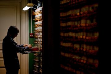 A man looking for items on the shelves (many of which are in the dark) in the Russian State Library in Moscow, Russia, 2018. To illustrate that a lack of archival access have transformed Russia studies