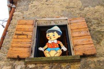 Pinocchio in the window building store of wooden toys in San Marino Pinocchio in the window building store of wooden toys in San Marino