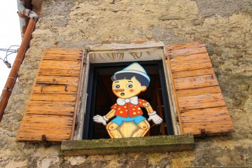 Pinocchio in the window building store of wooden toys in San Marino 