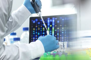 Scientist pipetting sample into a vial for DNA testing