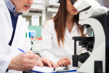 Scientists collaborating in laboratory