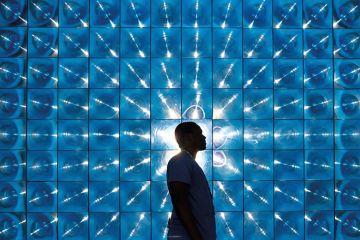 man silhouetted against kaleidoscope screen