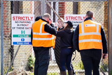Security staff try to secure the building after squatters were evicted from the University of Brighton's former Circus Street campus.