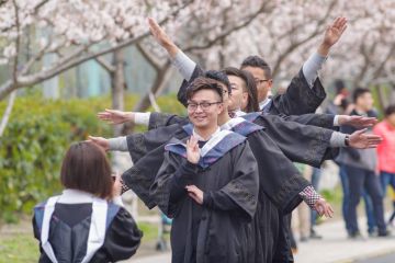 Shanghai happy graduation, students taking photos in cherry festival in Tongji University.