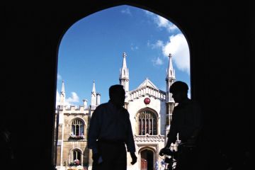 Silhouettes of men standing in university entrance Silhouettes of men standing in university entrance